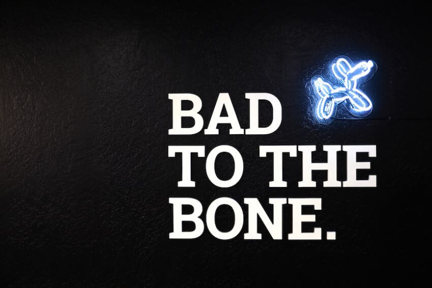 bad to the bone white letters on black wall