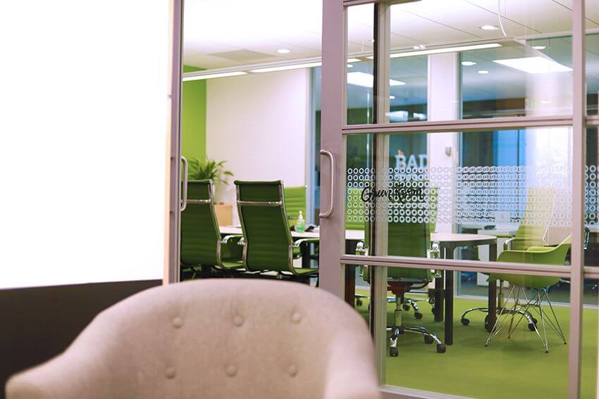 green conference room from over a grey chair